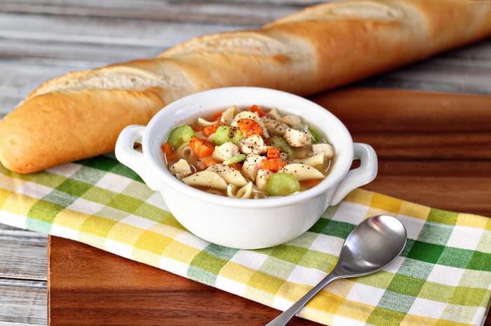 Chicken noodle soup with baguette