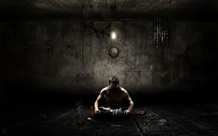 Man sitting in a dark room with a clock and flag