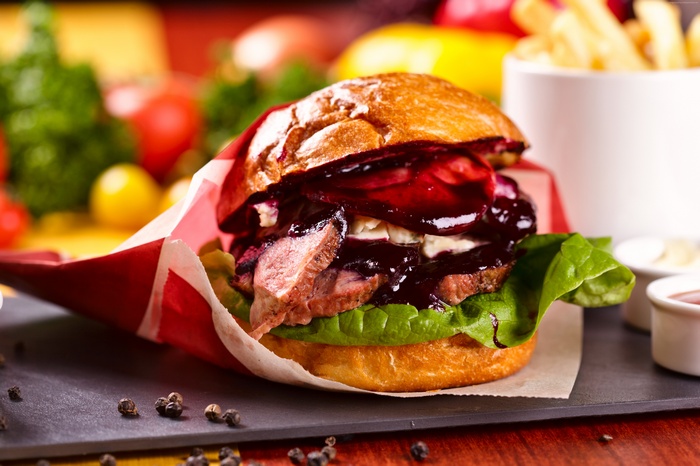 Steak burger with berry sauce and lettuce