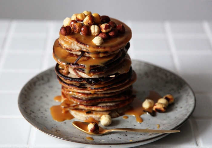 Stack of pancakes with caramel and hazelnuts
