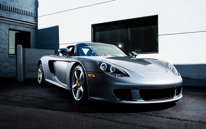 Silver Porsche Carrera GT convertible parked outdoors