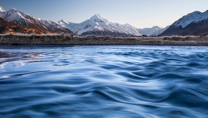 Snow-capped mountains and a flowing river