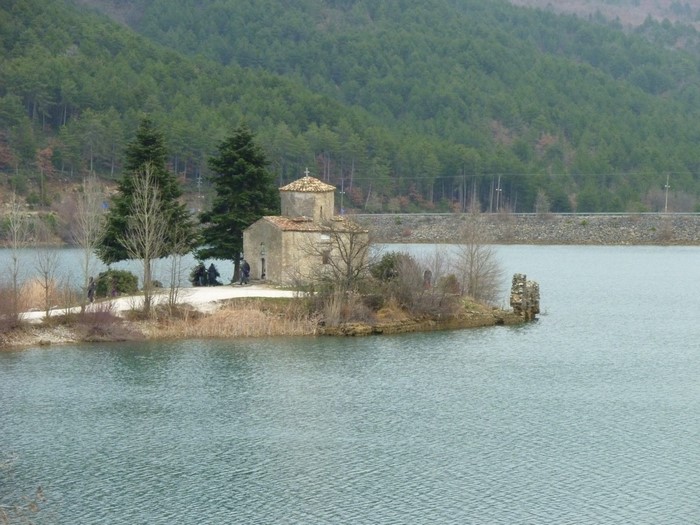 Small stone church on an island in a lake