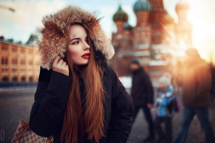 Woman with red hair and fur hood in Moscow