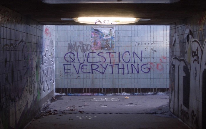 Graffiti tunnel with "Question Everything" text