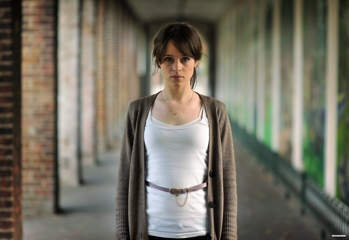 Claire Foy wearing a cardigan and tank top