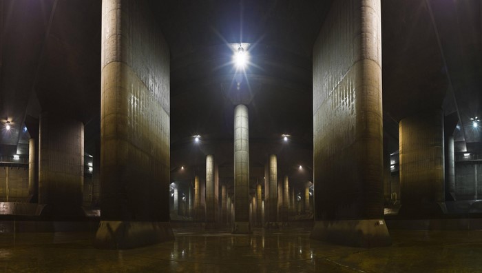 Underground concrete pillars with lights and reflections
