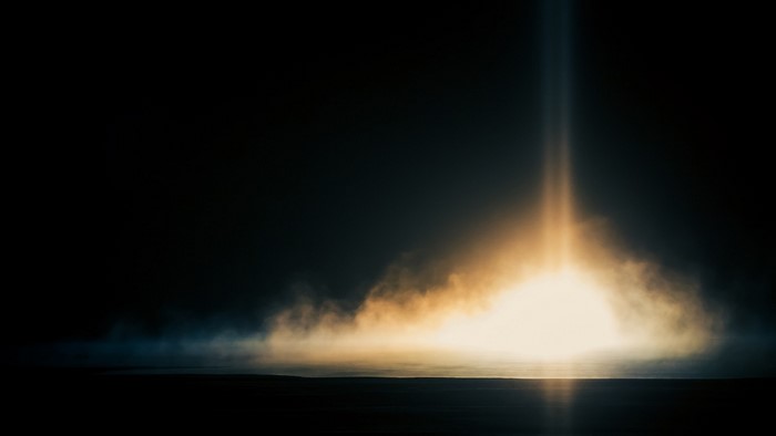 Bright light beam emerging from mist