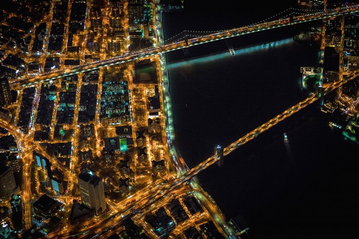 Aerial view of New York City bridges and cityscape at night