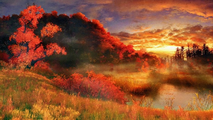 Autumn sunset over a misty landscape with red trees