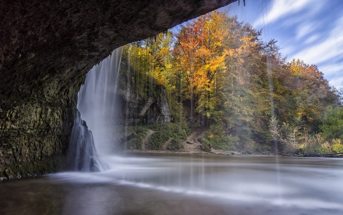 Waterfall in autumn forest with long exposure