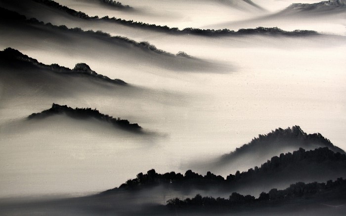 Monochrome mountain range shrouded in mist