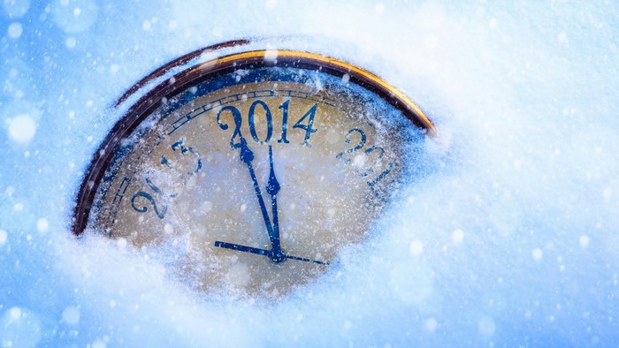 Clock covered in snow with the year 2014