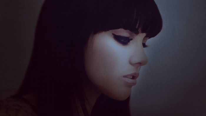Woman with dark hair and dramatic eye makeup