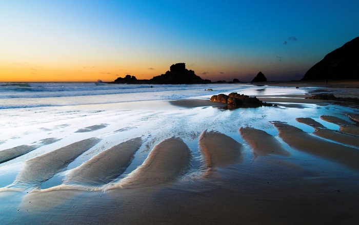 Beach with rock formations at sunset