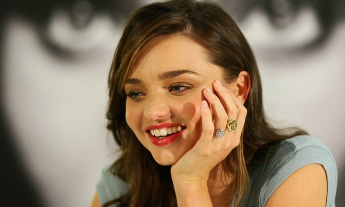 Miranda Kerr smiling with rings on her fingers