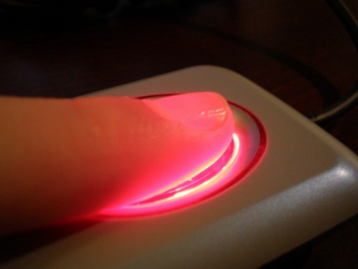 Finger on a red glowing scanner