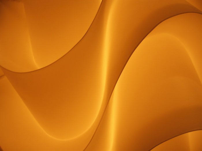 Abstract orange and yellow flowing shapes with light