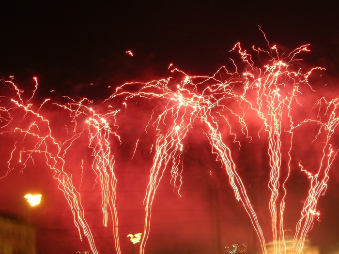 Red fireworks exploding in the night sky