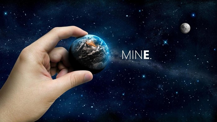 Hand holding Earth in space with moon and text