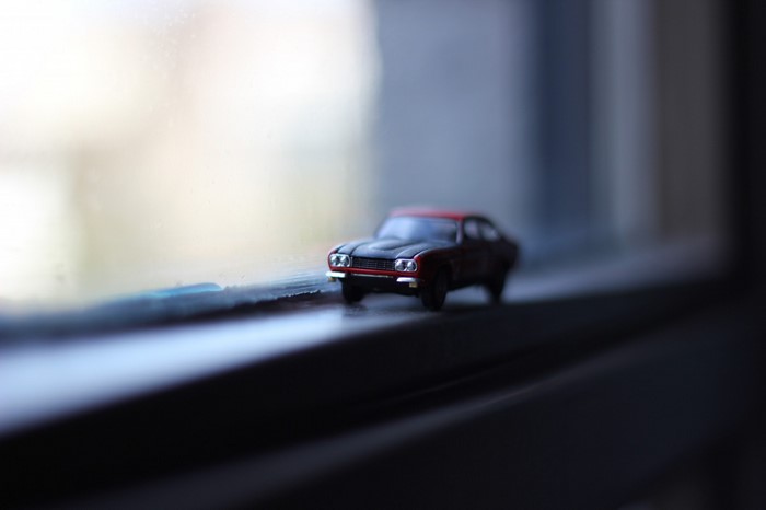 Red and black toy car on a windowsill