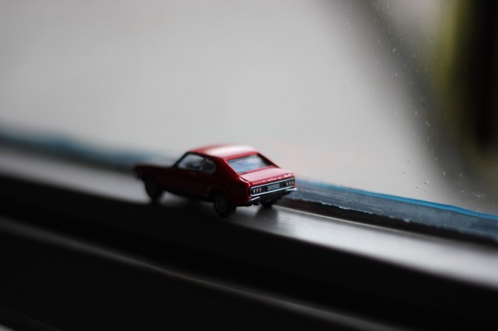 Red toy sports car on a windowsill