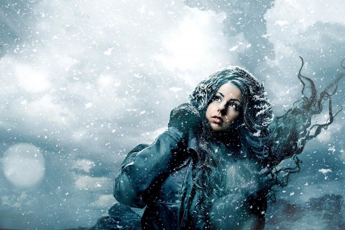 Woman in a snowy environment with wind-blown hair