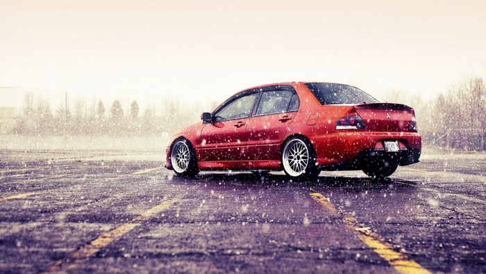 Red Mitsubishi Lancer Evo IX in Snow
