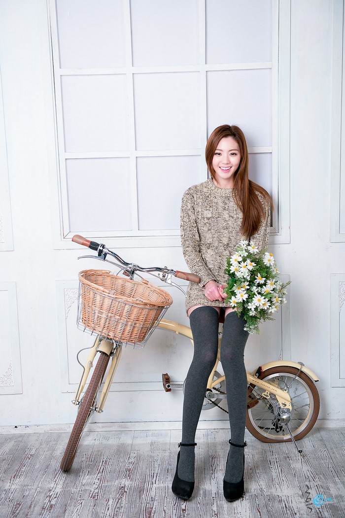 Chae Eun Sitting on Bicycle Holding Flowers