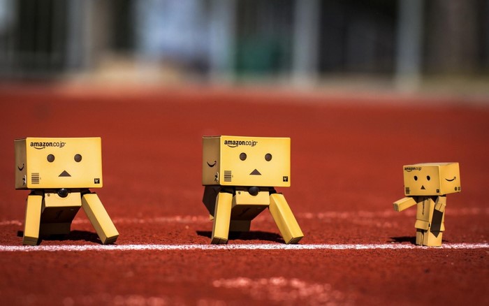 Three Amazon Danbo figures on a running track