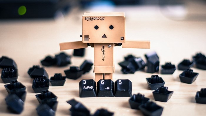 Danbo toy with Amazon logo surrounded by keyboard keys