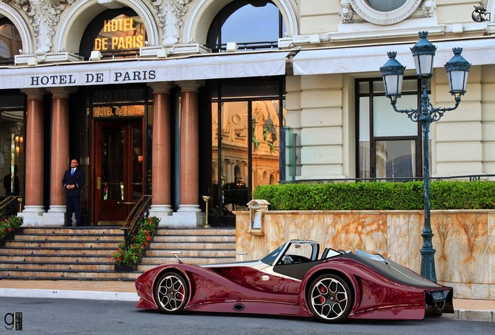 Maroon sports car parked in front of Hotel de Paris