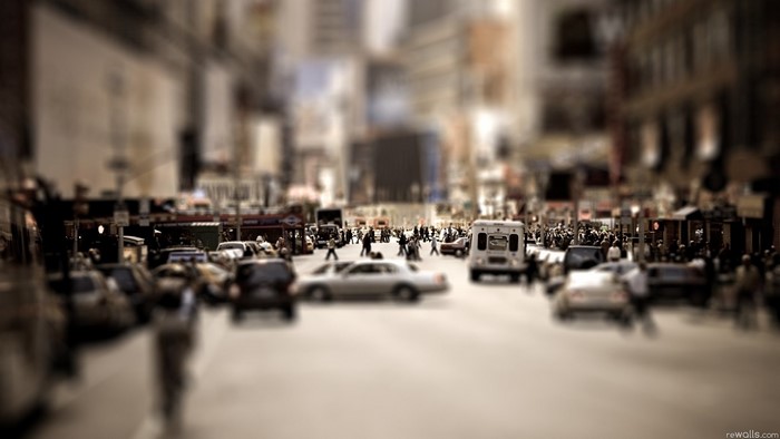 City street with cars and people, tilt-shift effect