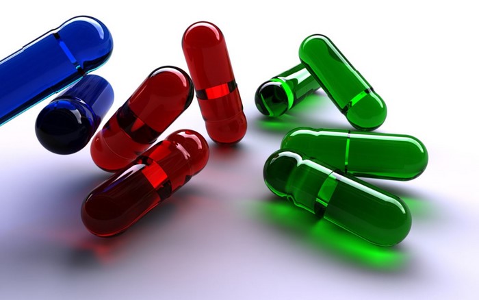 Transparent Blue, Red, and Green Capsules on White Background