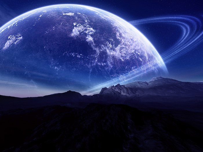 Planet with rings over mountainous landscape in space