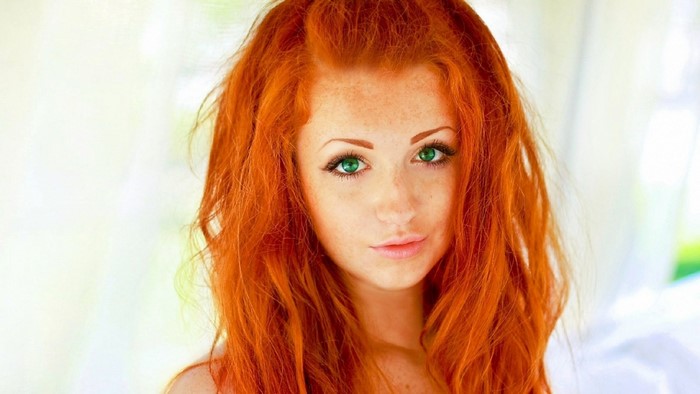Redhead woman with green eyes and freckles