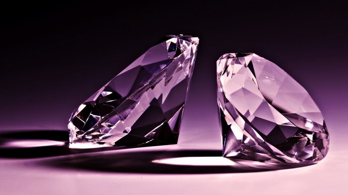 Two purple diamonds on a dark background