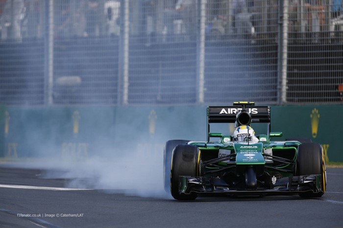 Formula 1 race car with smoke on track