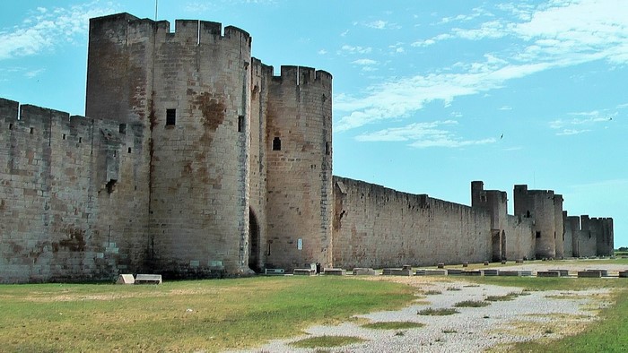 Fortified medieval walls and towers under a blue sky