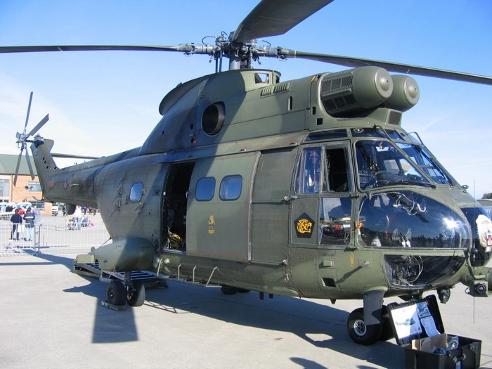 Green military helicopter on display