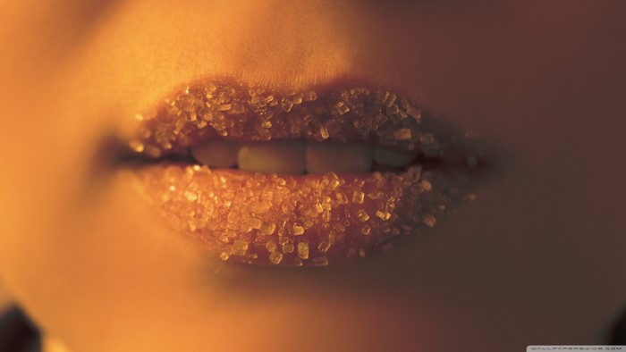 Close up of lips covered in sugar