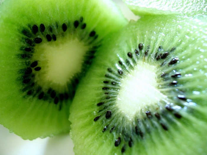 Close-up of two sliced kiwis