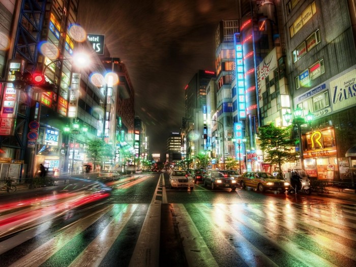 Nighttime street scene in Japan with neon lights and traffic