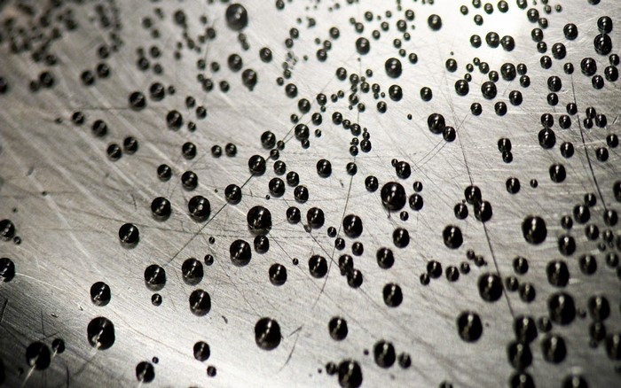 Close-up of water drops on a textured surface