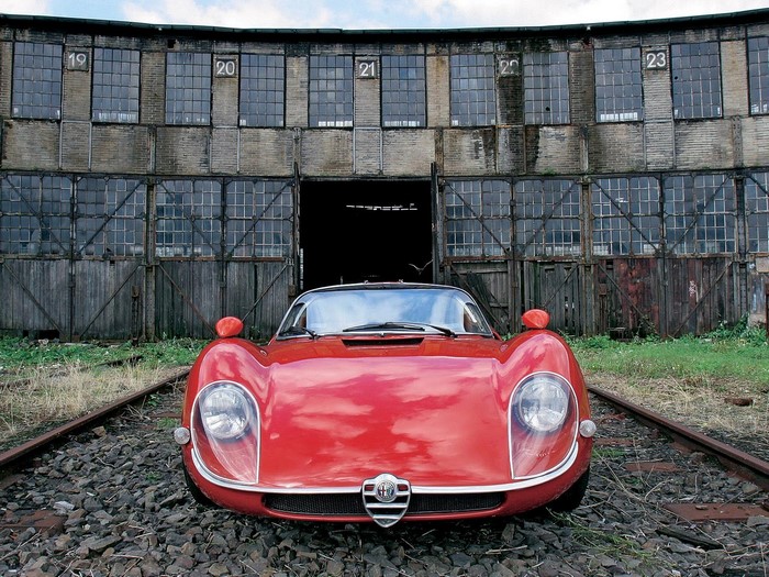 Red Alfa Romeo 33 Stradale on train tracks