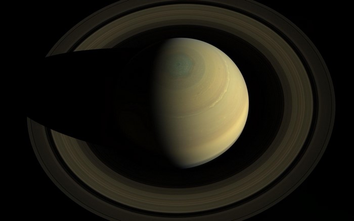 Saturn and its rings casting a shadow