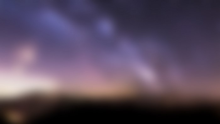 Blurred night sky with aurora and faint light