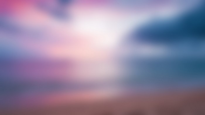 Blurred sky with pink and blue clouds at sunset