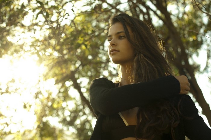 Woman with long hair in sunlight outdoors