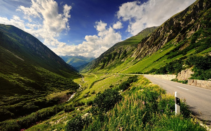 Mountain valley with a road and a stream